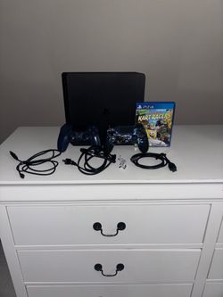 PS4 Slim with 2 controllers and game.