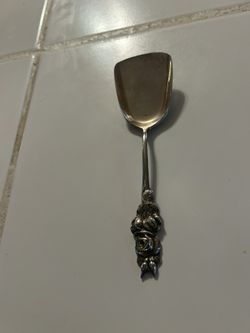 vintage Reed & Barton silver-plated serving utensil, likely a nut scoop or bon bon spoon from the "Harlequin" pattern, recognized by the detailed rose