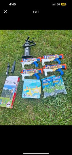 This image shows a lot of toys for outdoor activities and water parties, including four XSHOT Sonic