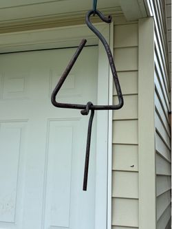 Rusty, wrought iron dinner bell.