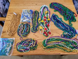 At least  100 plastic party necklaces