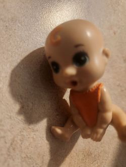 Small Baby Doll Figure with Orange Outfit