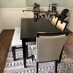 Dark wood and glass dinning table with 4 chairs and bench. So rug under table is available fo ($40)