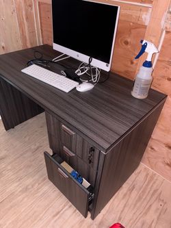 executive-style office desk with 3 drawers and a locking drawer
