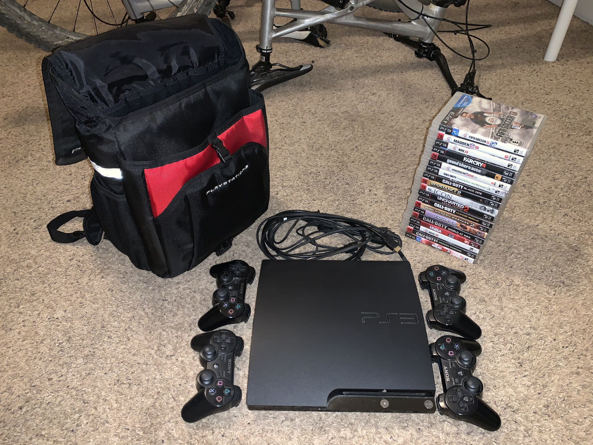 PS3 w/ 19 games, 4 controllers, traveling case