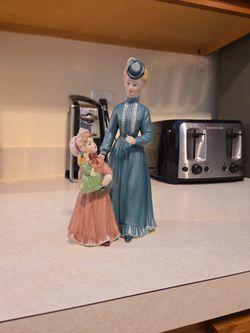 Antique porcelain lady and child holding a doll