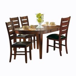 Brand new oval dark oak dining table with self-storing butterfly extension leaf (61.75 x 43.25 x 30H) + 4 brown faux leather chairs