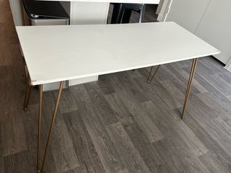White table with golden support legs