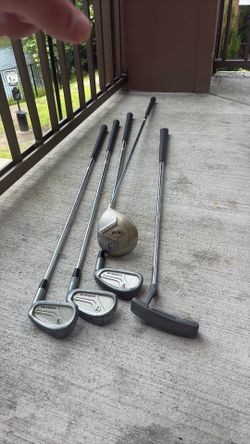 Used set of golf clubs including irons, putter, and 3 iron.