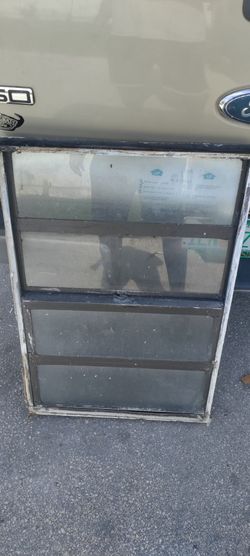 Exterior bronze aluminum non-impact single home window approximately 25.5x75.25