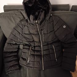 Calvin Klein Sorona Aura black hooded puffer jacket with faux-fur lining in the hood. 
