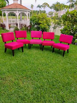 5 armless accent or slipper chairs with magneta velvet like cover and dark wood legs. Wide cushion seat and angled back