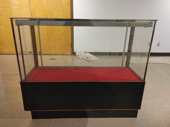 Wooden and glass display case with glass shelving, lights, and storage