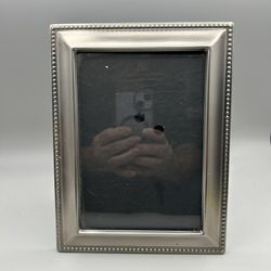Pretty Silver Frame In Great Condition.  Holds 5” x 7” Picture.  Stands Vertical or Horizontal.