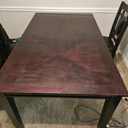 Dark wood dining room table and four chairs