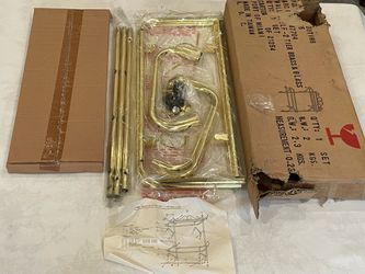 Vintage new-old-stock two-tier brass and glass wall shelf in its original packaging.