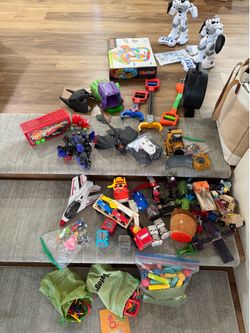Assorted toys: transformer, train, cars, robots and more