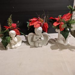 Three Vintage Angel Statues With Christmas Flowers