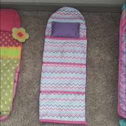A bed for an 18 inch doll and two sleeping inflatable sleeping bags all for $10