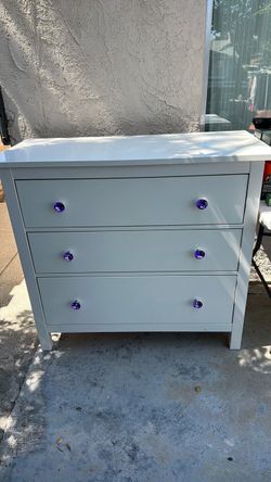 IKEA dresser with custom purple glass knobs: