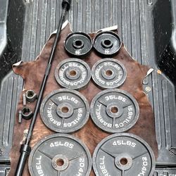 SET OF CAP OLYMPIC PLATES :  45s  35s  25s  10s   & 7  FOOT OLYMPIC BARBELL BAR 