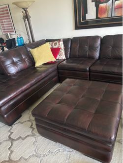 Dark brown leather sectional with storage Ottoman and additional centerpiece