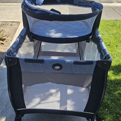 Graco Pack n Play w/ newborn Sleeper on top.