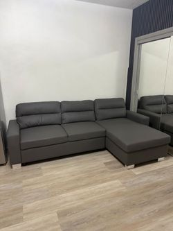 Couch with reversible love seat can be on left or right side folds into a bed with storage