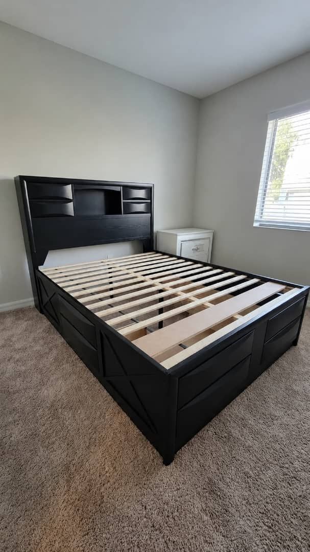 Queen bed with drawers and shelving. Down payment $85