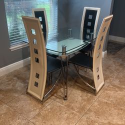 Glass Table With 4 Black And White Chairs