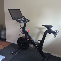 Peloton Bike With Shoes, Water Rack, And Weight Rack