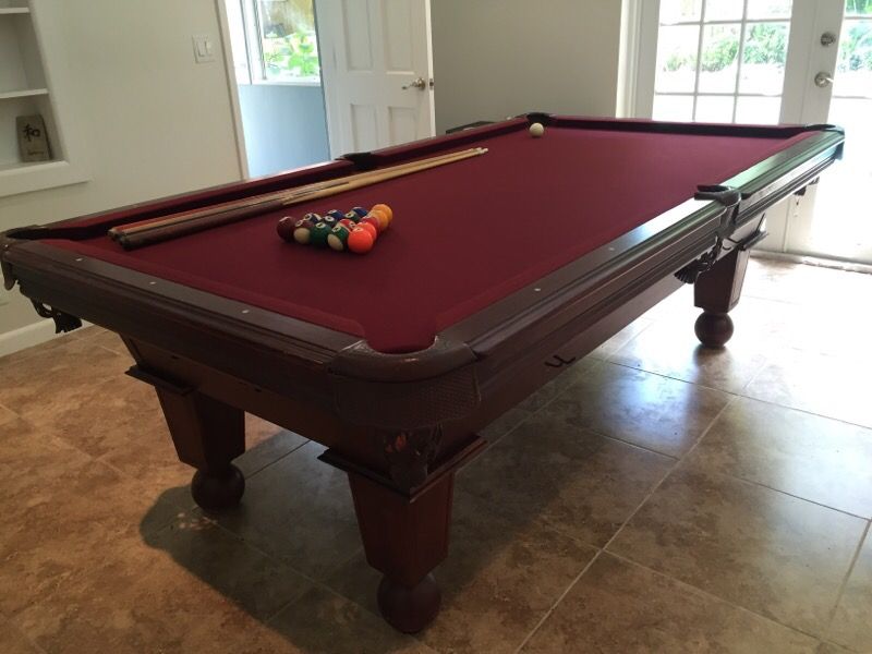 8 foot slate pool table by Leisure Bay. Bumpers and felt recently redone. Very intricate furniture piece.