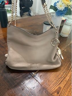 Michael Kors Lillie Large Leather Shoulder Tote in a taupe or beige color.