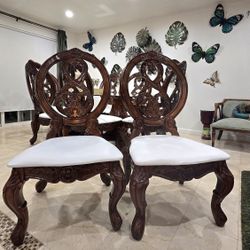 Two elegant, carved, solid-wood chairs