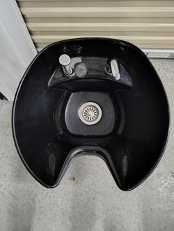 Tilting shampoo bowl