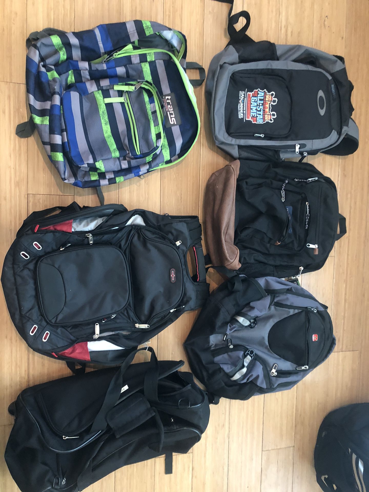 5 great condition backpacks w laptop pouches (Oakley, Jansport and Swiss) plus rolling bag
