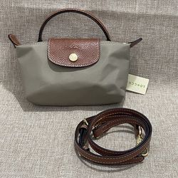 Longchamp's light gray mini dumpling bag is versatile. 