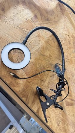 flexible gooseneck LED ring light with a clamp base, commonly used for selfies, makeup application, or desk lighting. 