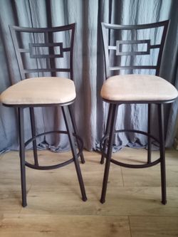 Set of two metal bar stools with upholstered seats