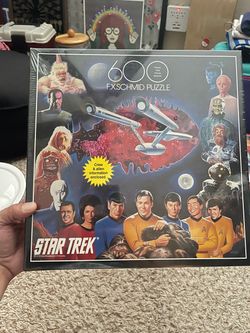 vintage 1993 600-piece "Star Trek" jigsaw puzzle manufactured by F.X. Schmid, featuring artwork of the original series cast and various aliens.