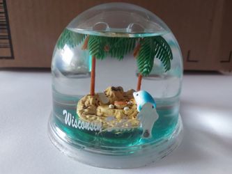 souvenir featuring an island with two dolphins inside a  globe,  an official Wisconsin Dells item.