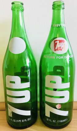 2 vintage large 7up soda bottles