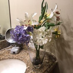 Silk floral arrangement in glass vase