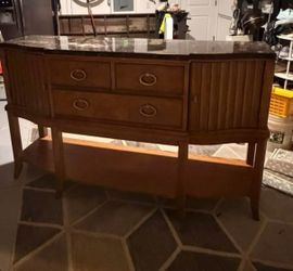 Furniture sideboard featuring a sleek black marble top