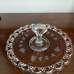 Clear pressed glass serving tray with center handle and etched floral design