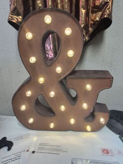 vintage-style metal ampersand marquee sign featuring 14 LED lights for a rustic, industrial look.