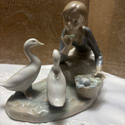 Lladro porcelain figurine, specifically model #4849 titled "Feeding the Ducks".