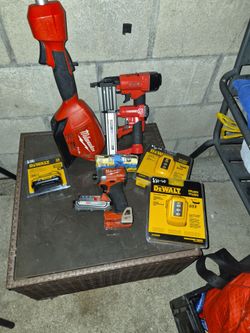 A couple mixed power tools Milwaukee and Dewalt,  Arrow