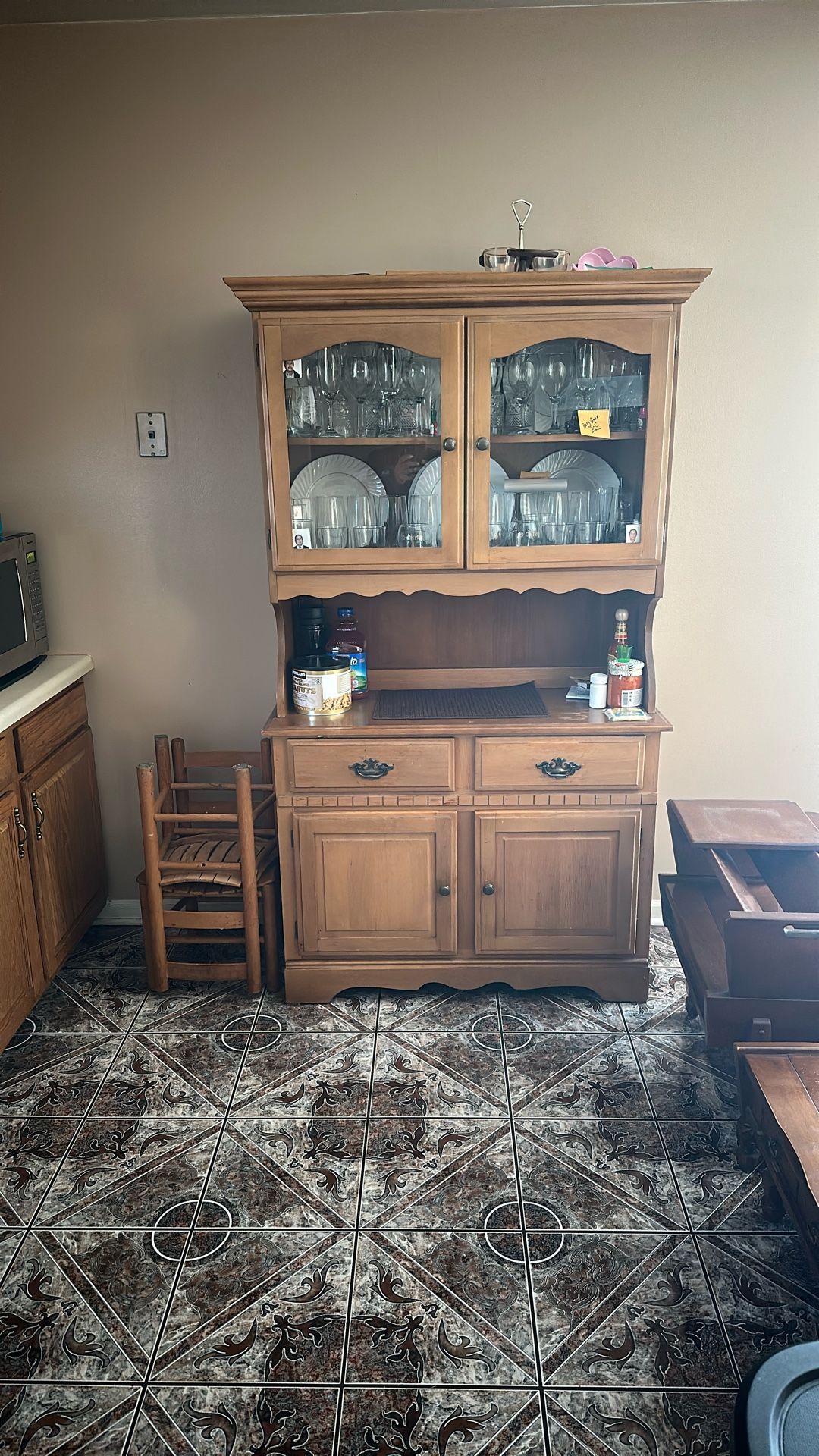 This is a wooden hutch or china cabinet. 