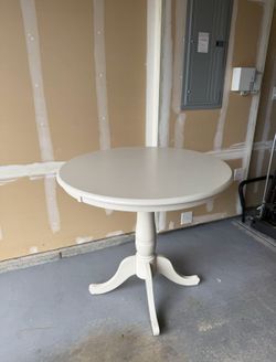 Round wood pedestal table